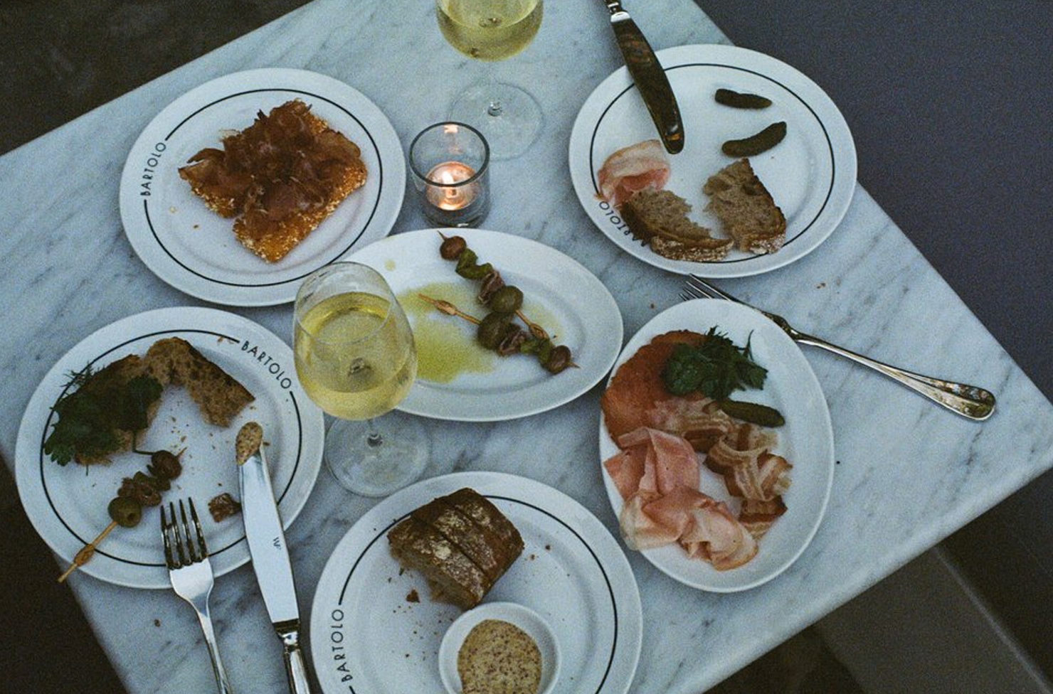 a spread of half eaten appetisers on a marble table
