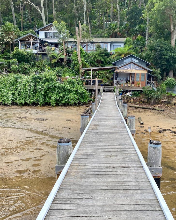 jetty leading towards shoreline of beach hut in sydney