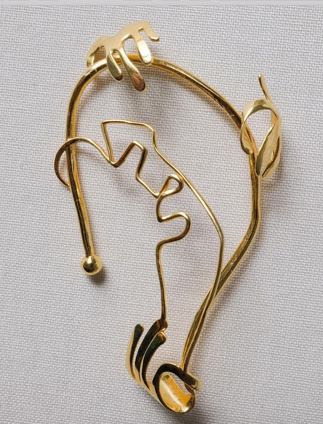 a piece of gold ear jewellery