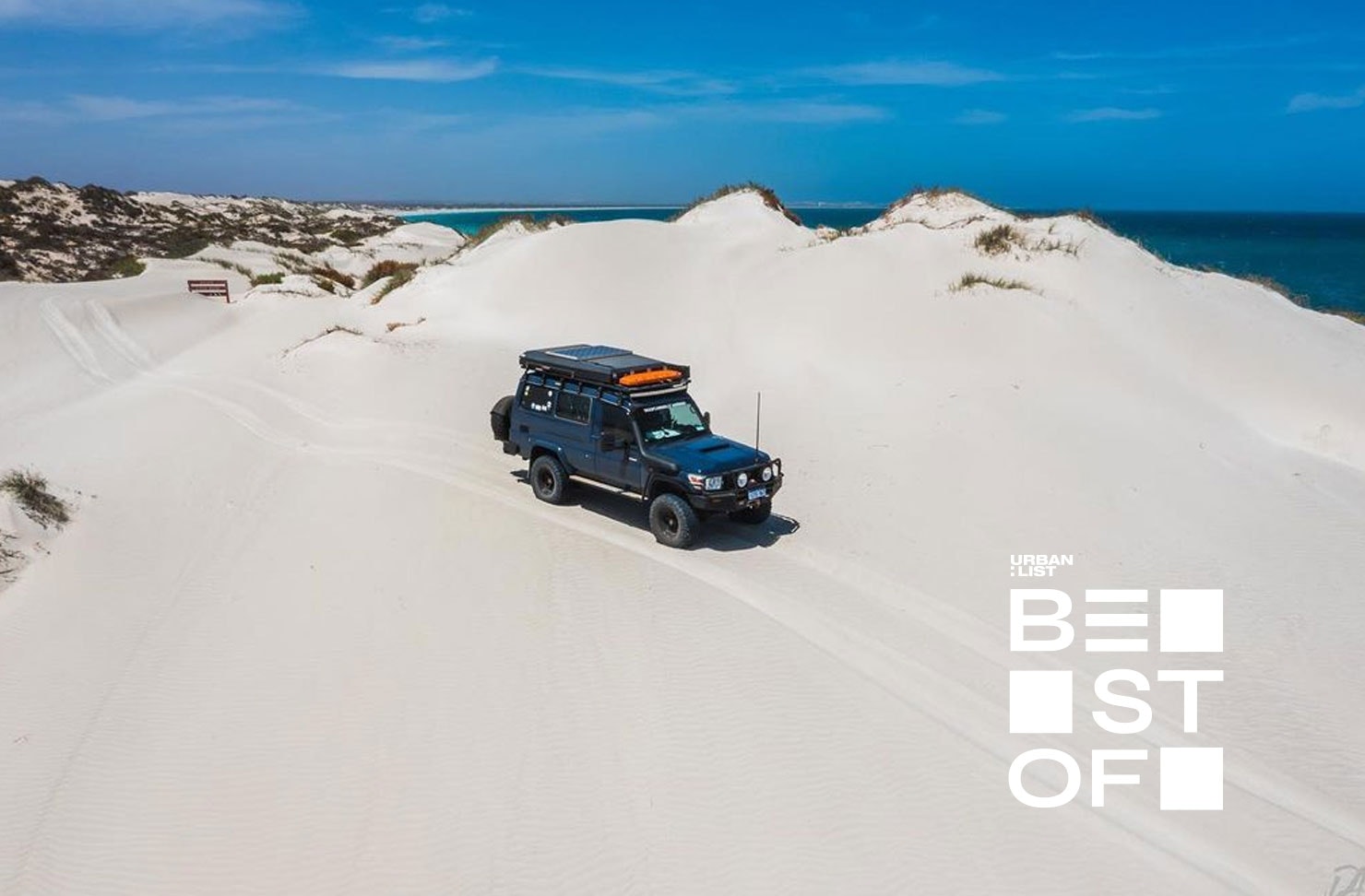 a troop carrier driving over sand