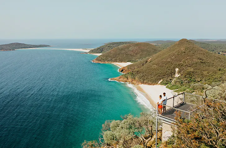 two people looking out over tropical bay
