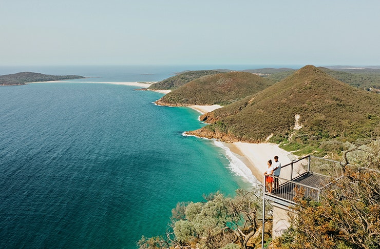 two people looking out over tropical bay