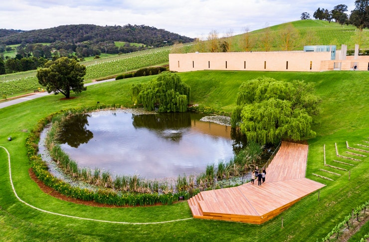 aerial of museum in valley with small pond