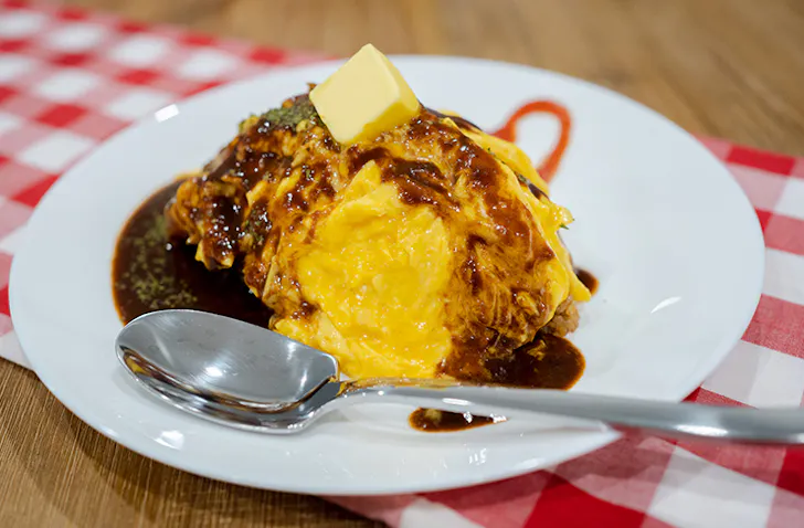 plate of omurice with demi glace sauce