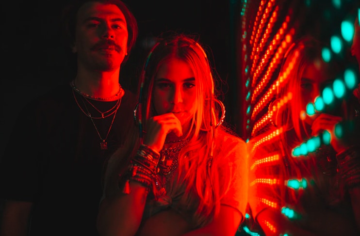 girl and boy standing near LED lights
