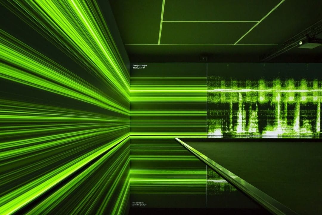 An artwork of Neon light in a dark room at the Sydney Biennale. 