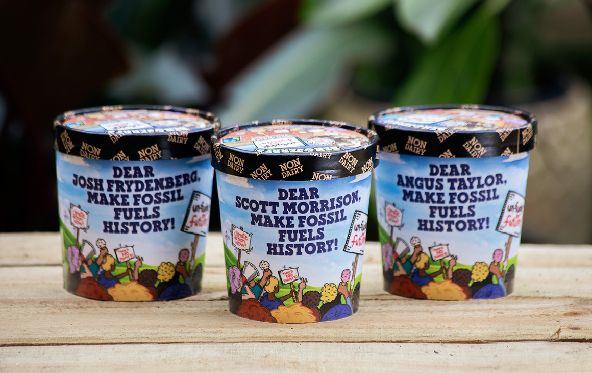 three tubs of ice-cream on a bench.