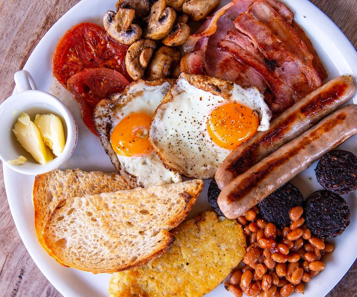 beans, sausages, eggs, bacon on a plate