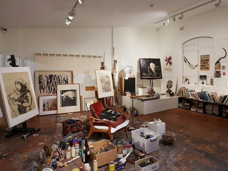 an artists studio with canvases and paint