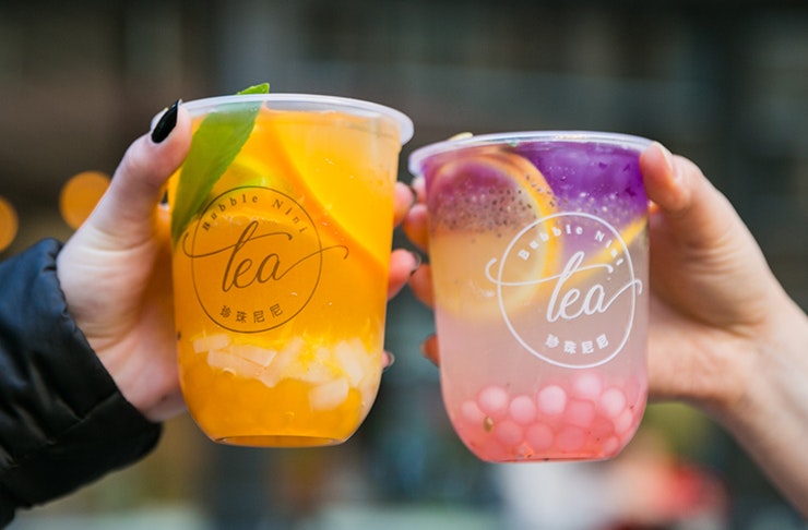 two hands 'cheersing' bubble tea