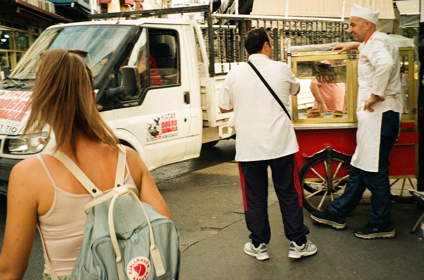 people on the street near a food stall