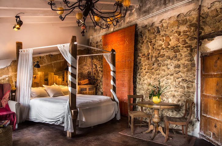 a room with a four post bed