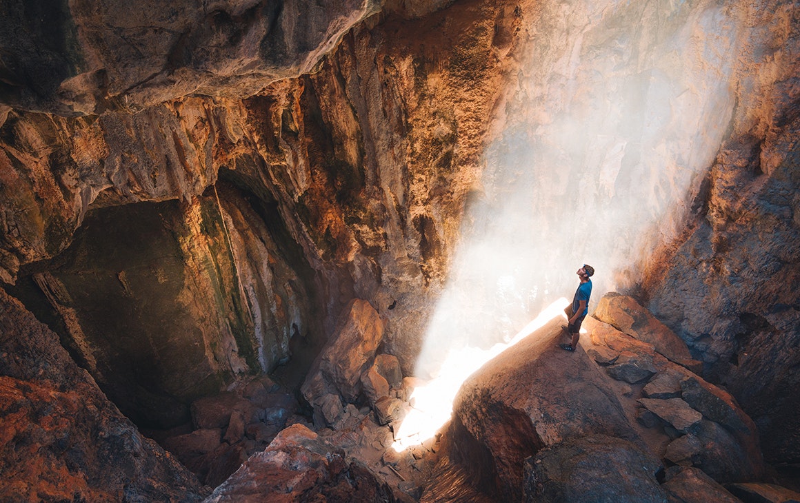 A man stands on the edge of Pompeii Cave