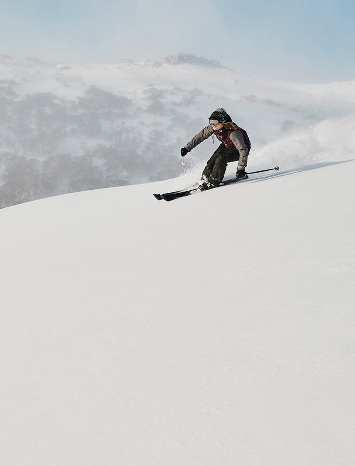 person skiing down snowy mountain
