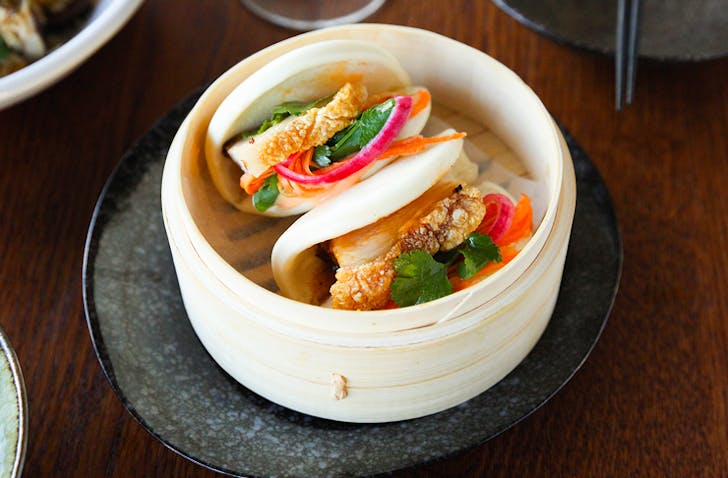 cripsy pork bao buns in bamboo tray