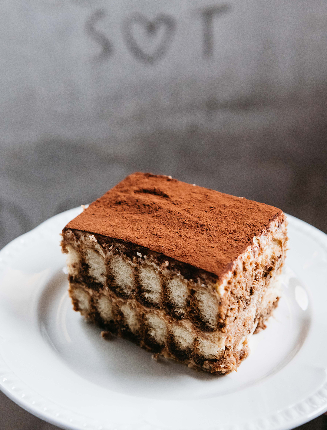 massive slice of tiramisu on a plate