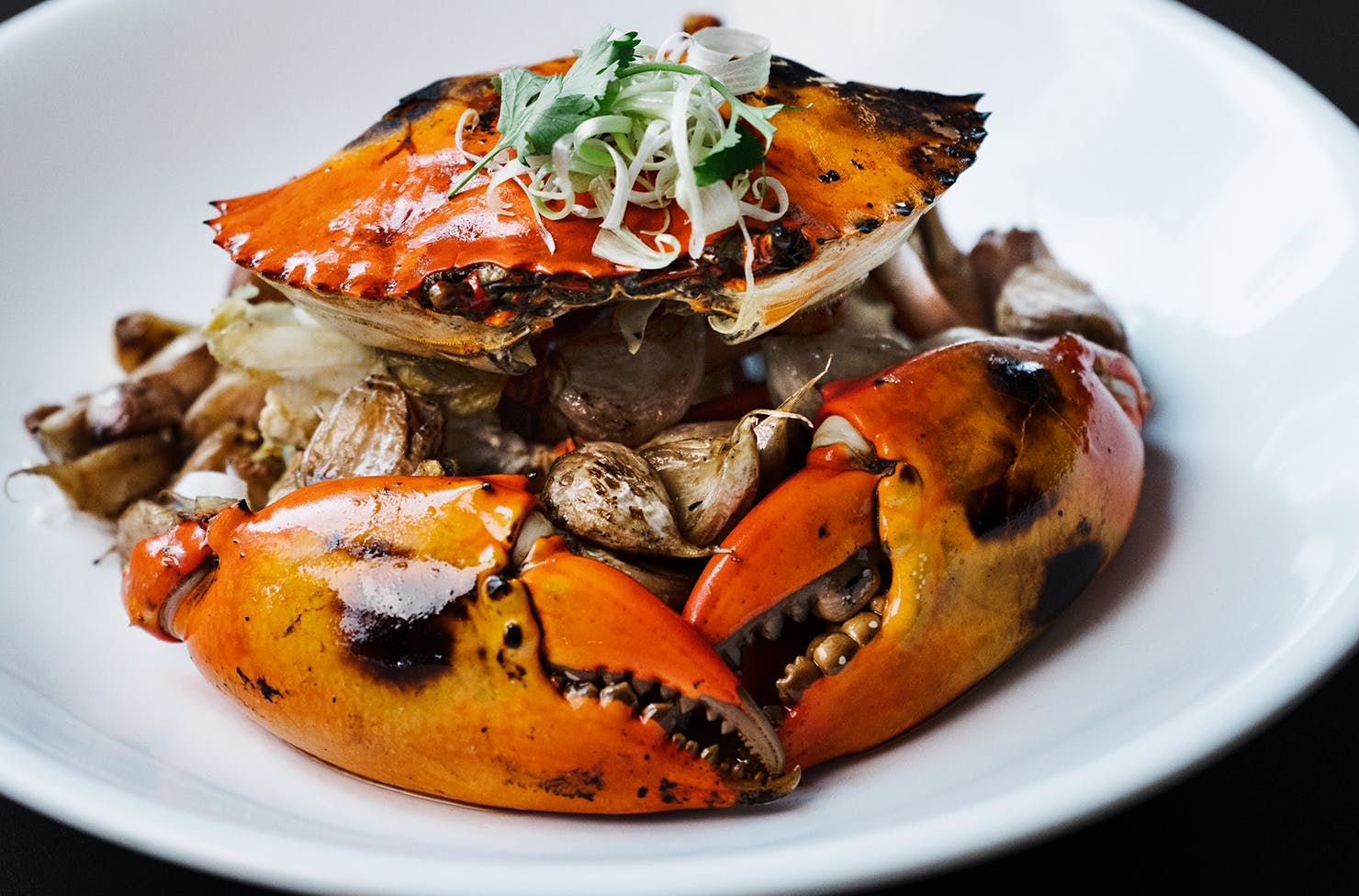 A decadent and Singaporean specialty crab dish on a while plate.