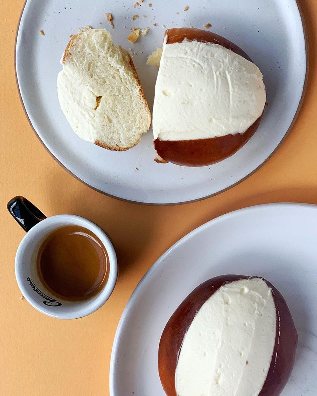 two cream buns with coffee 