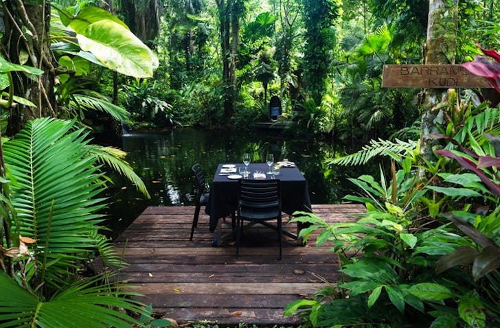 table and chair set up near creek