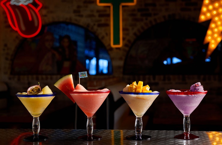 four slushie margaritas on bar top