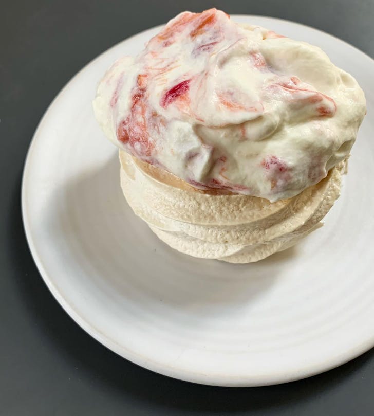 a meringue with strawberry cream on top