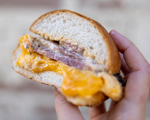 hand holding brisket roll