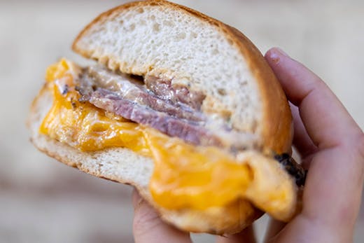 hand holding brisket roll