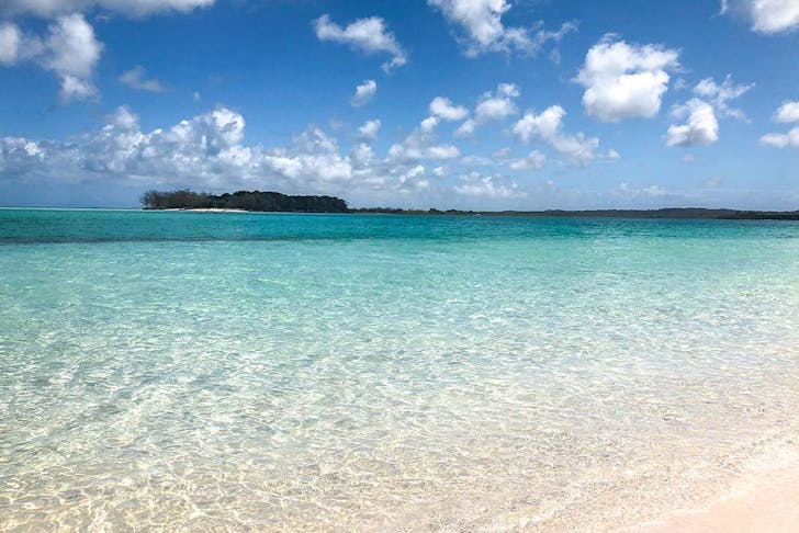 Crystal clear water of Fraser Island meets a white sand beach