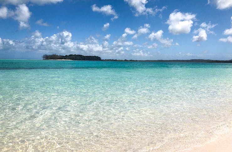 Crystal clear water of Fraser Island meets a white sand beach