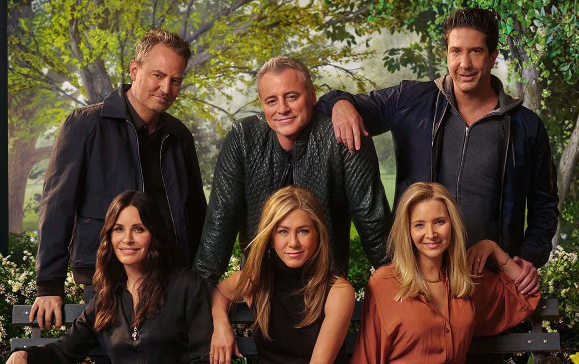 The cast of friend huddle around a couch for the reunion special