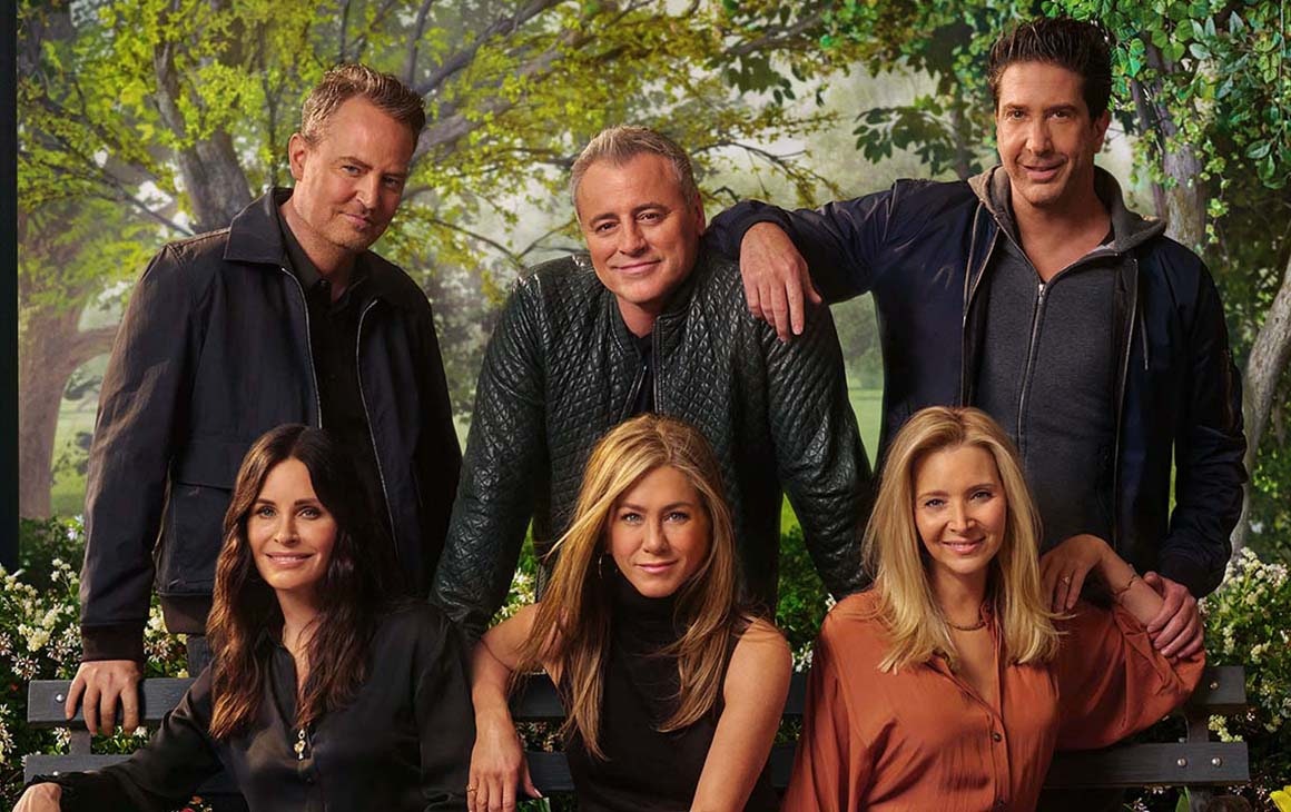 The cast of friend huddle around a couch for the reunion special