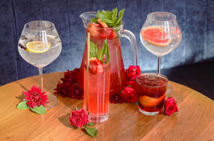 gin cocktails and gin sangria lined up on a wooden table