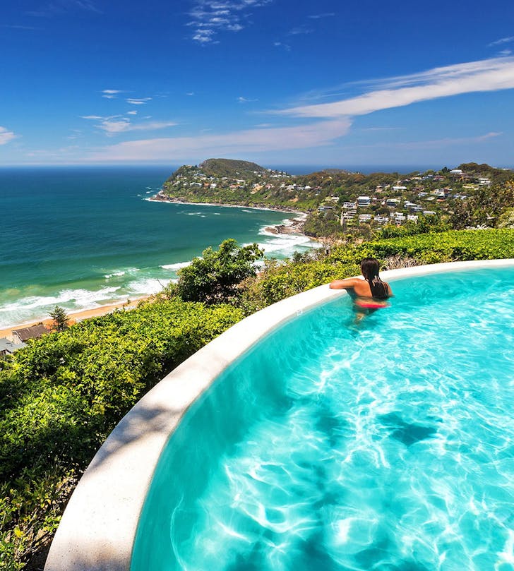 swimmer leaning over infinity pool