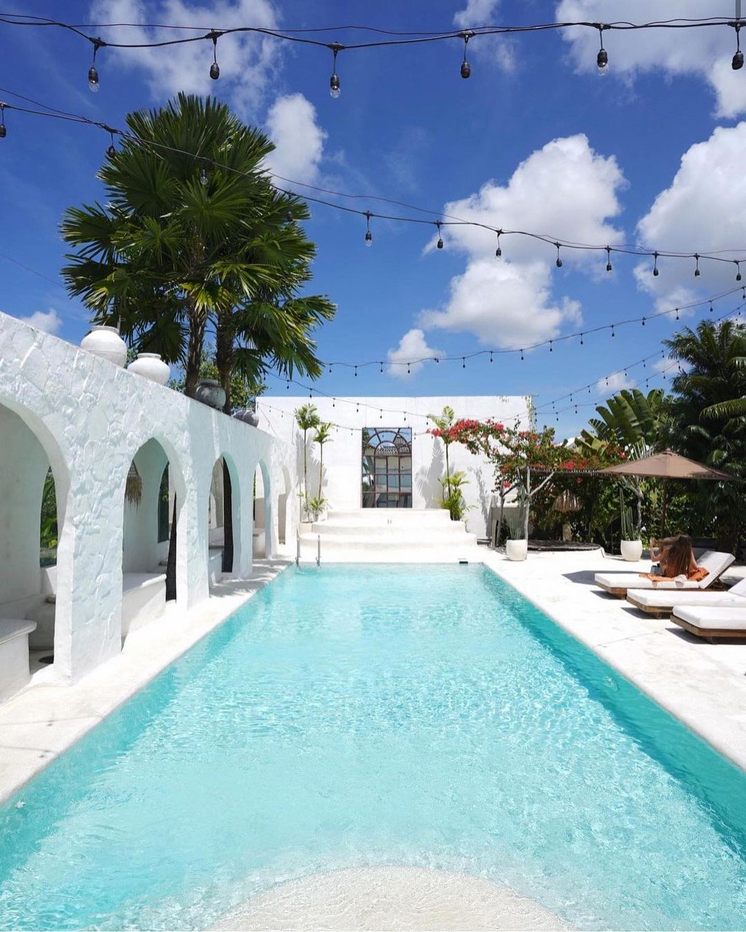 a luxury pool with festoon lights