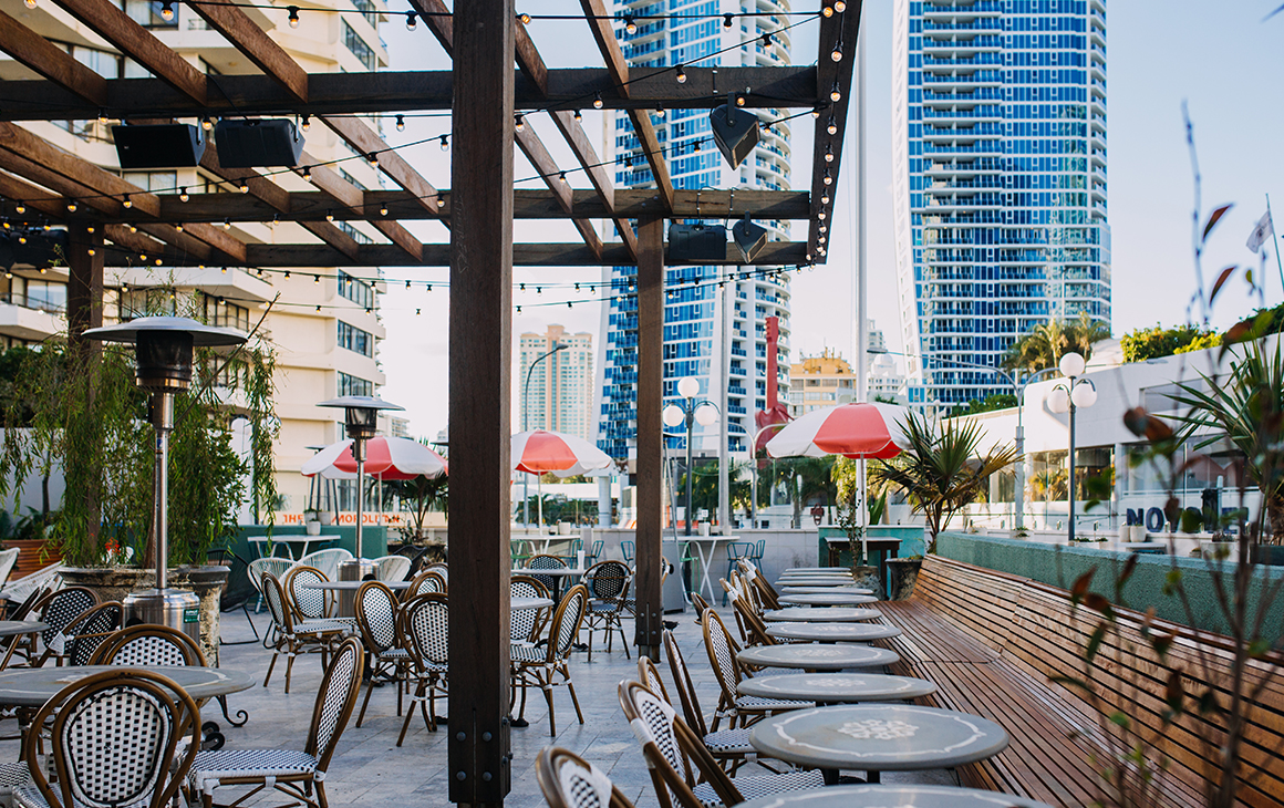 a rooftop bar with fairy lighting