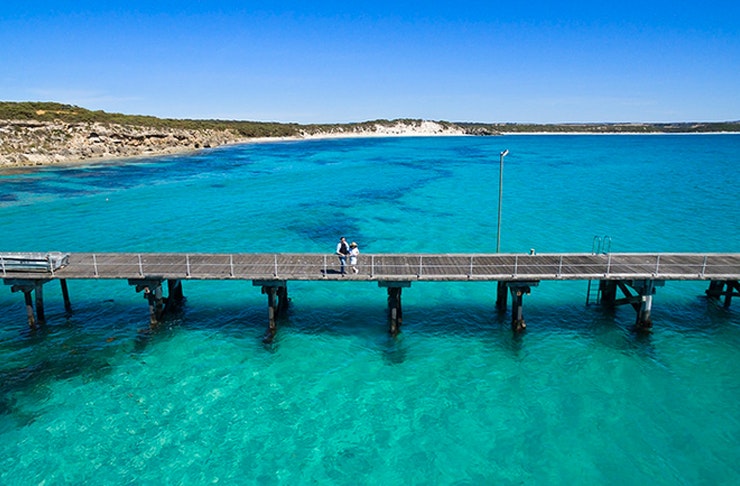 two people standing on a jetty