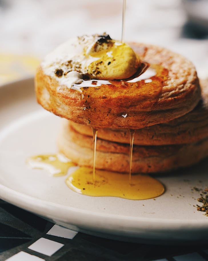stack of crumpets with date molasses drizzled on top