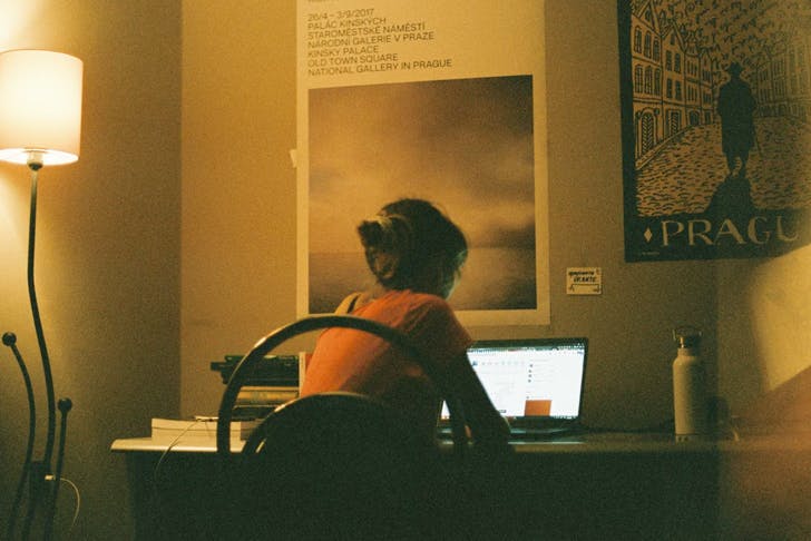 person sitting at desk on laptop