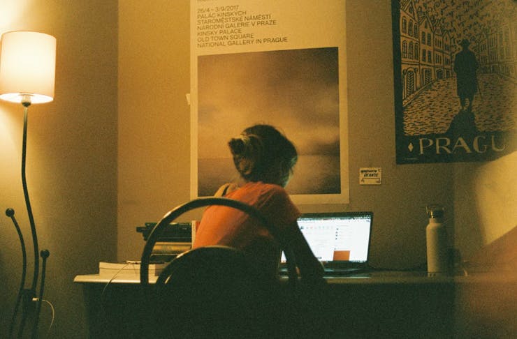 person sitting at desk on laptop