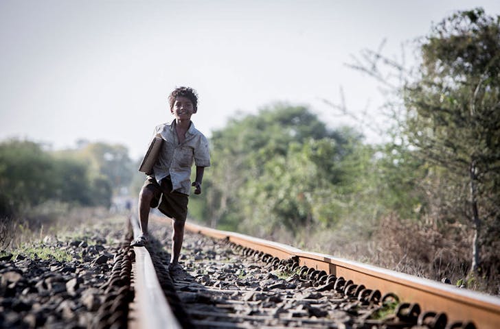 a young person standing on a train track
