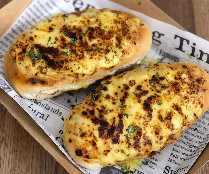 lobster roll with melted cheese on top