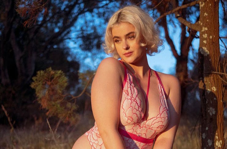 a person standing in a field wearing lingerie