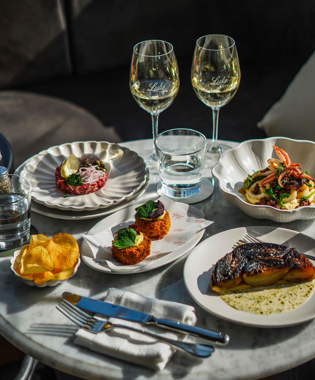 a spread of french food and wine on a table