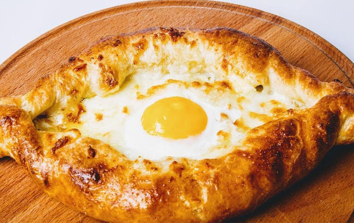 Khachapuri with a runny egg in the middle.
