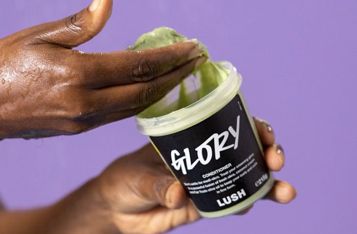 hand dipping into tub of conditioner