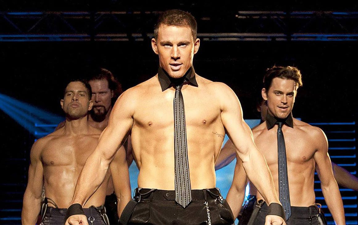 three topless men dance on stage in a scene from Magic Mike the film.
