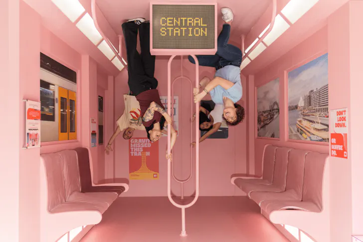 two people in an upside train carriage