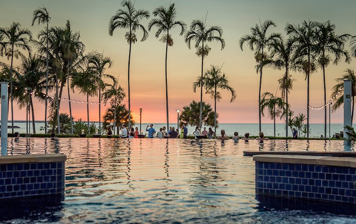 a dusty pink sunset in Darwin from the pool at Mindil Beach Resort