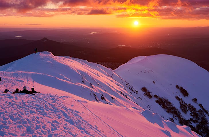sunset over snow mountains