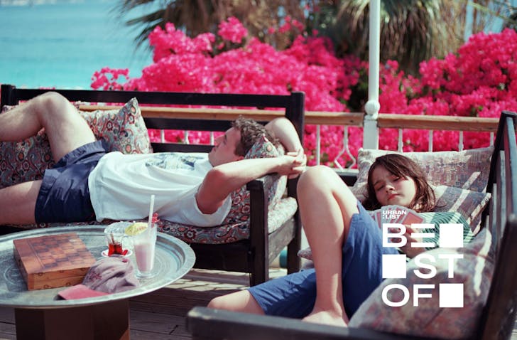 two people sitting on sunbeds relaxing